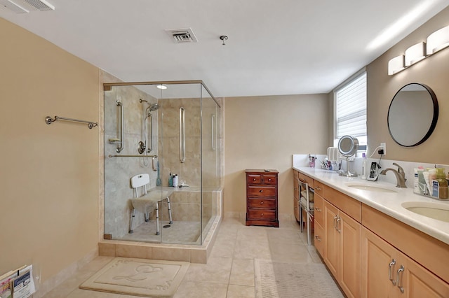 bathroom with vanity, an enclosed shower, and tile patterned floors