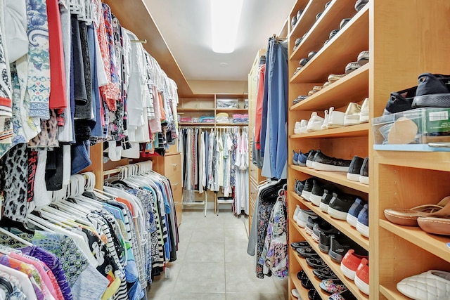 walk in closet with light tile patterned floors