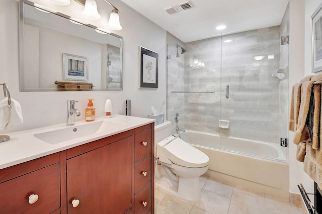 full bathroom featuring toilet, tile patterned flooring, vanity, and enclosed tub / shower combo