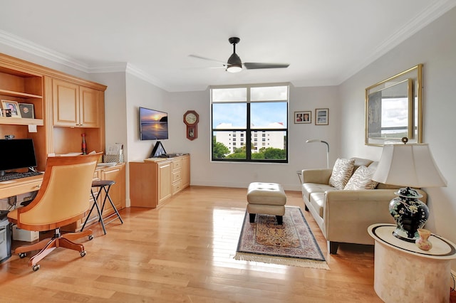 living room featuring ceiling fan, light hardwood / wood-style floors, and crown molding