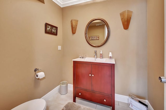 bathroom with toilet, vanity, tile patterned flooring, and crown molding