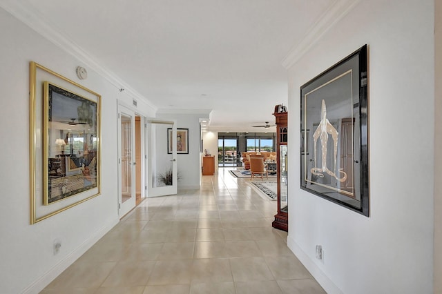 hallway with french doors, light tile patterned floors, and crown molding