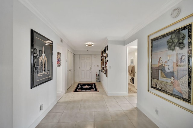 hallway featuring ornamental molding and light tile patterned floors