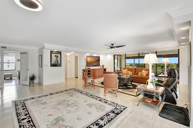 tiled living room with ceiling fan and ornamental molding