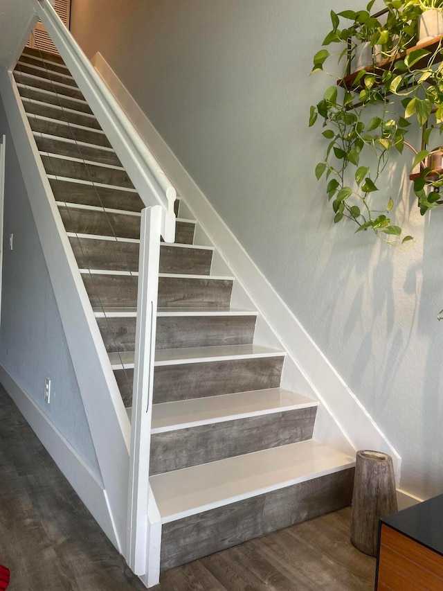 staircase featuring hardwood / wood-style flooring