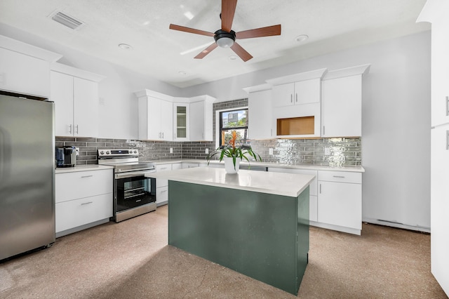 kitchen featuring stainless steel appliances, white cabinetry, ceiling fan, and a kitchen island