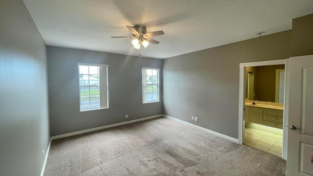 carpeted empty room with a textured ceiling and ceiling fan