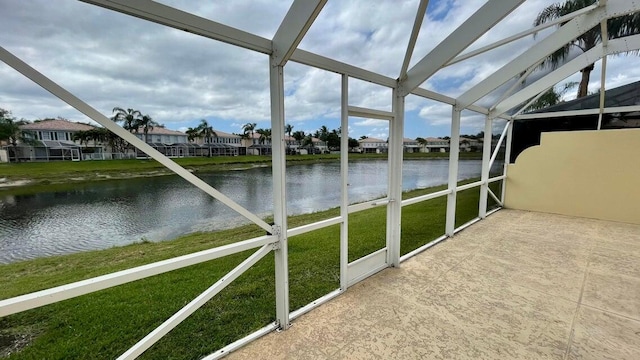 unfurnished sunroom with a water view and vaulted ceiling