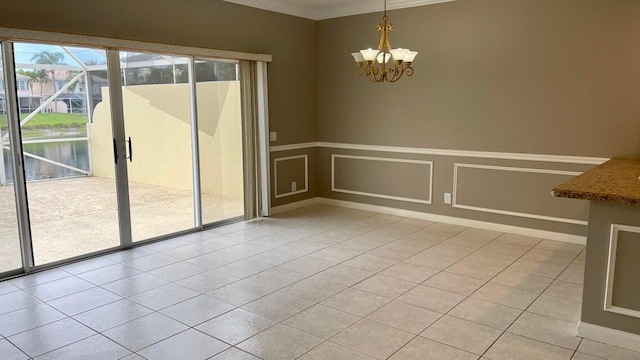 unfurnished dining area with crown molding, light tile patterned flooring, and a chandelier