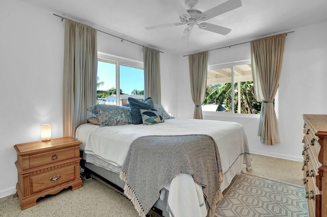 bedroom with multiple windows and ceiling fan