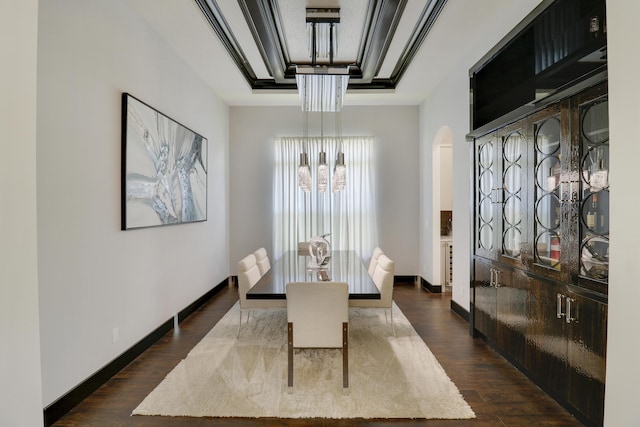 dining room with dark wood-type flooring and an inviting chandelier