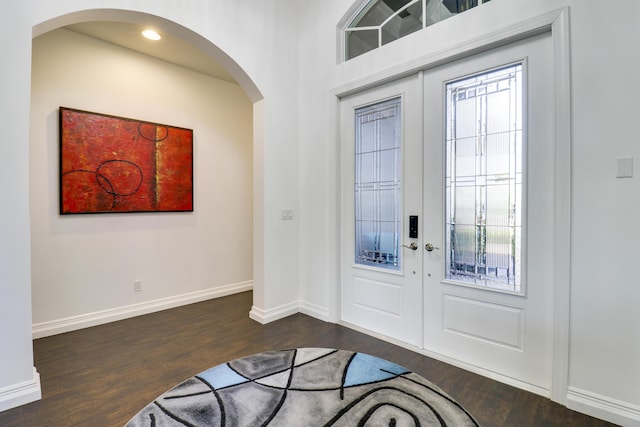 foyer featuring plenty of natural light, dark wood-type flooring, and french doors