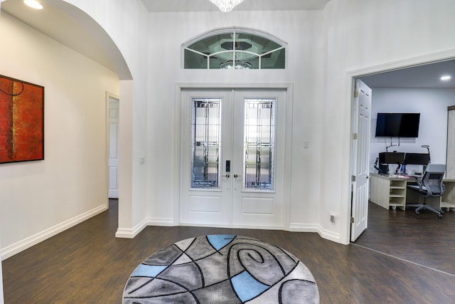 foyer featuring dark wood-type flooring, french doors, and a high ceiling