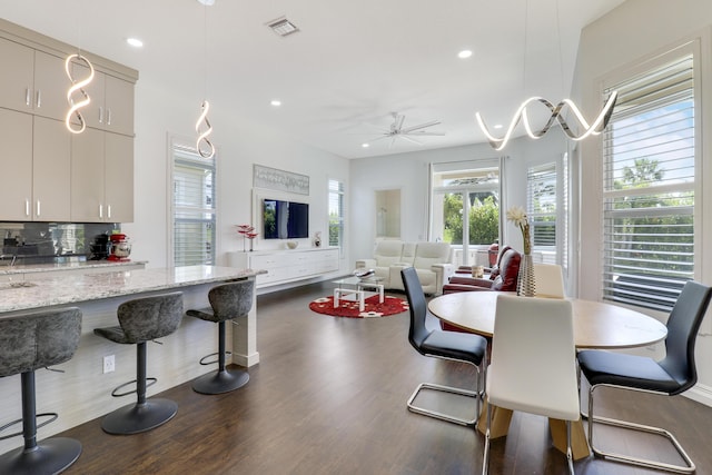 dining space featuring dark hardwood / wood-style floors and ceiling fan