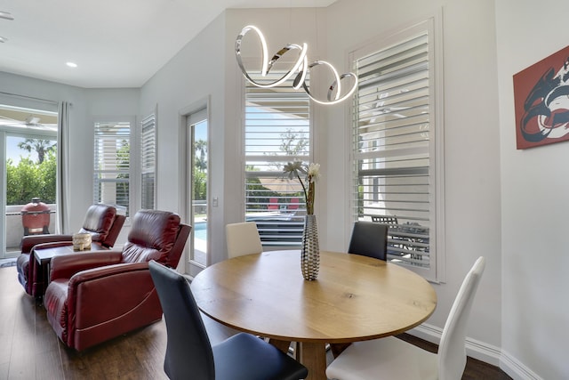 dining space with a notable chandelier and dark wood-type flooring