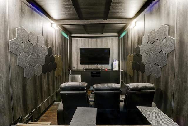 home theater room featuring beam ceiling and dark hardwood / wood-style flooring