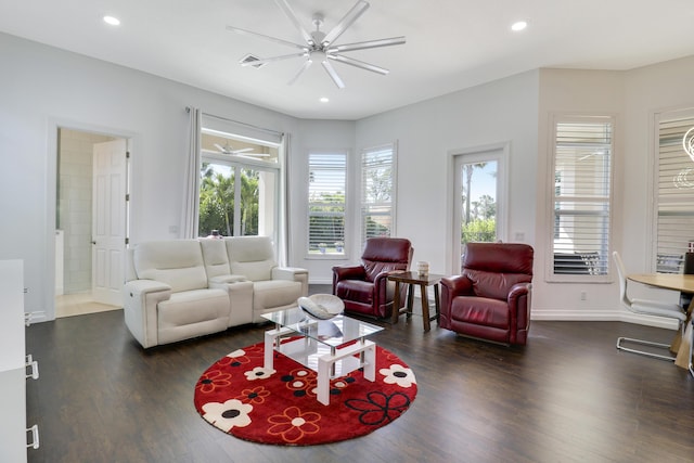 living room featuring dark hardwood / wood-style flooring and ceiling fan