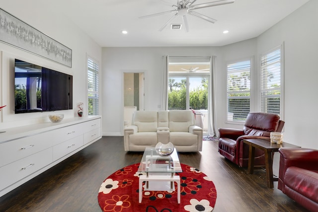 living room featuring ceiling fan and dark hardwood / wood-style flooring