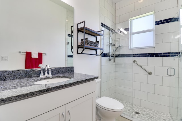 bathroom with vanity, an enclosed shower, and toilet