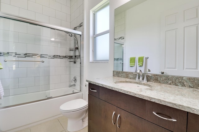 full bathroom with enclosed tub / shower combo, vanity, toilet, and tile patterned floors