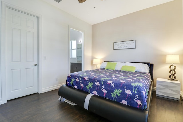 bedroom with ceiling fan, ensuite bath, and dark hardwood / wood-style floors