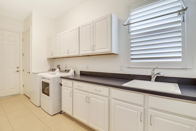 washroom with cabinets, light tile patterned flooring, sink, and washer and clothes dryer