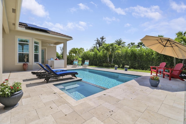 view of pool featuring an in ground hot tub, ceiling fan, and a patio