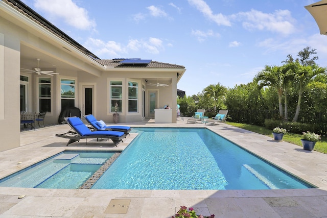 view of pool with ceiling fan and a patio area