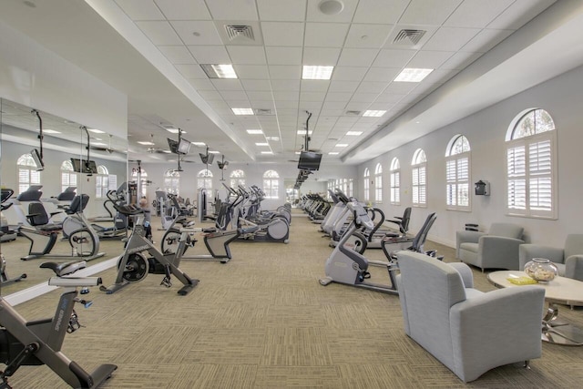 gym with a drop ceiling and light colored carpet