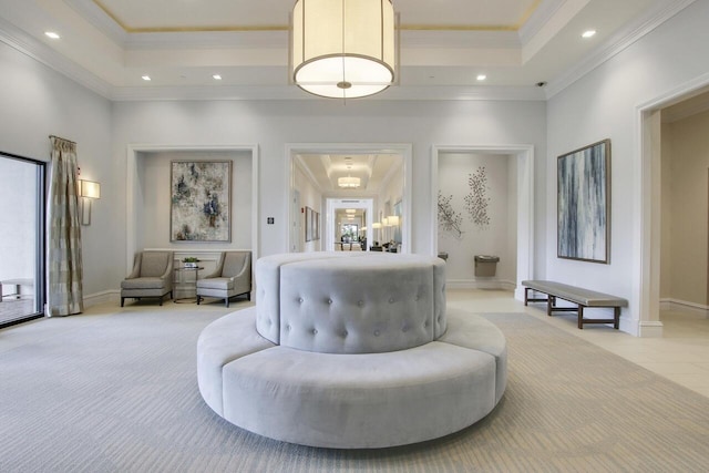 interior space with crown molding, a tray ceiling, and light colored carpet