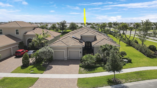 view of front of house featuring a garage and a front lawn