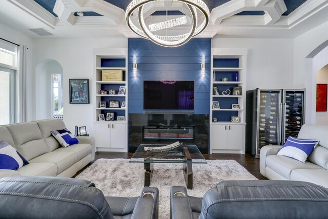 living room with coffered ceiling, dark hardwood / wood-style flooring, built in features, and beamed ceiling