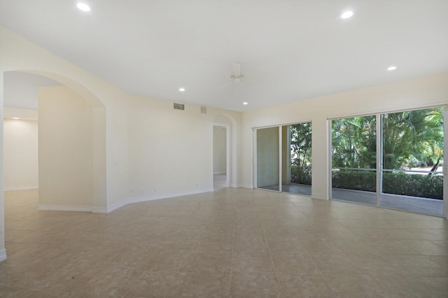 tiled empty room featuring ceiling fan