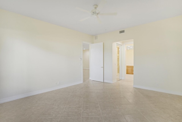 tiled empty room with ceiling fan