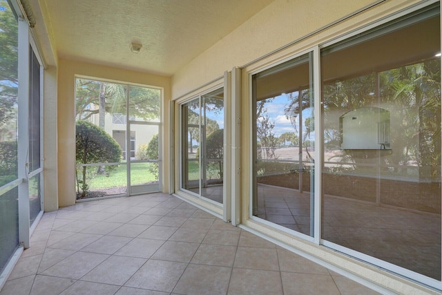7575 Orchid Hammock Dr, West Palm Beach, FL 33412 - unfurnished sunroom with tile patterned floors and a textured ceiling