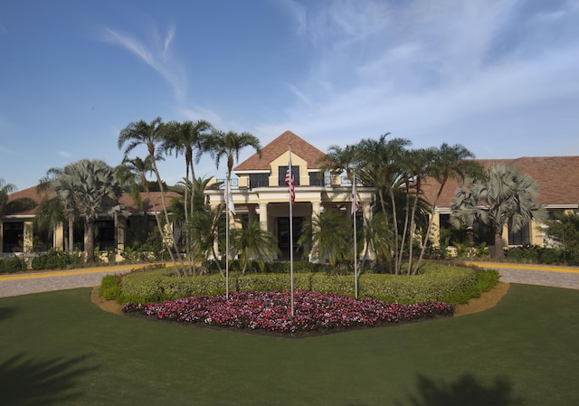 view of property's community with a lawn