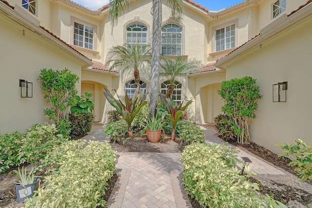 7575 Orchid Hammock Dr, West Palm Beach, FL 33412 - entrance to property with a tile roof and stucco siding