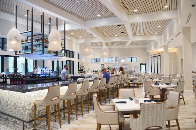 dining area with beamed ceiling, light wood-type flooring, and coffered ceiling