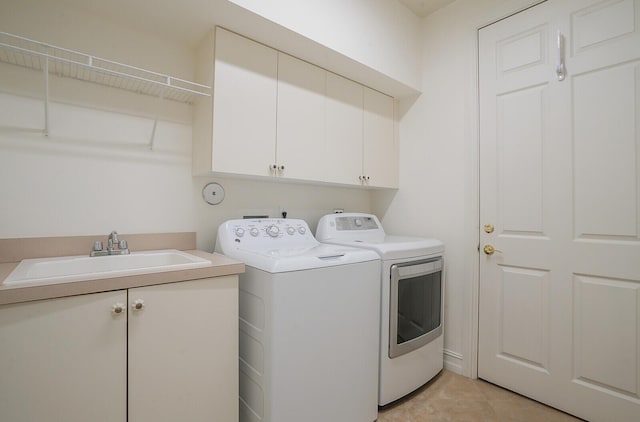 7575 Orchid Hammock Dr, West Palm Beach, FL 33412 - laundry room with cabinet space, separate washer and dryer, and light tile patterned flooring
