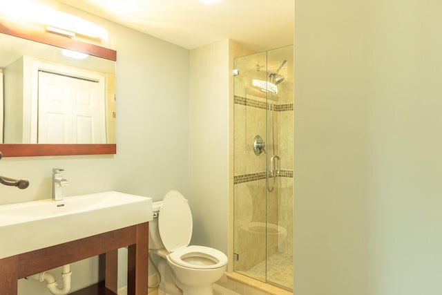 bathroom with toilet and an enclosed shower