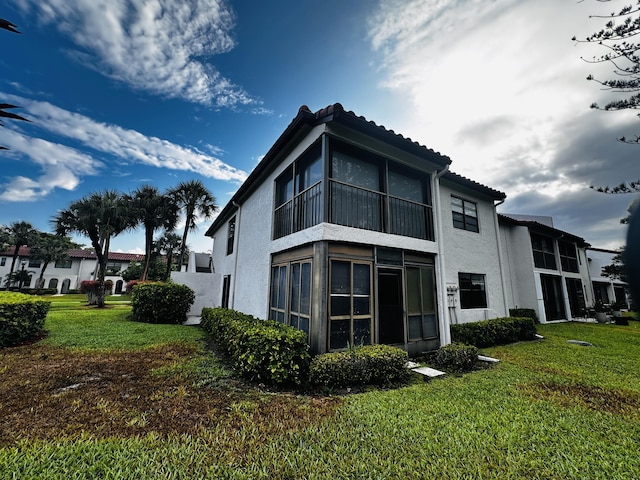 view of home's exterior with a lawn