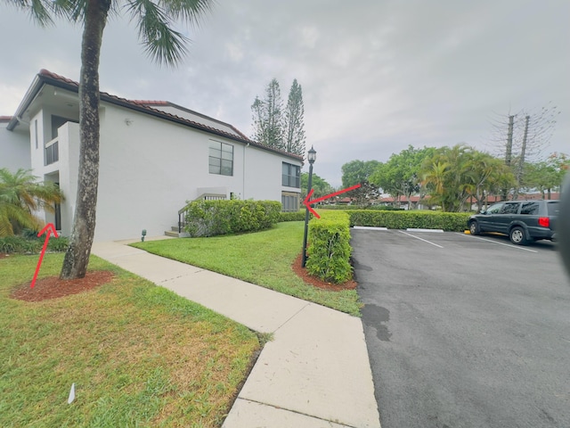 view of property exterior featuring a lawn