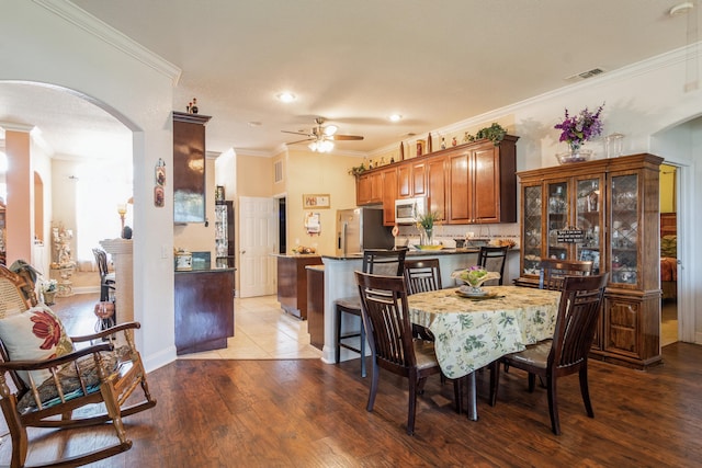 dining room featuring ceiling fan, light hardwood / wood-style floors, and ornamental molding