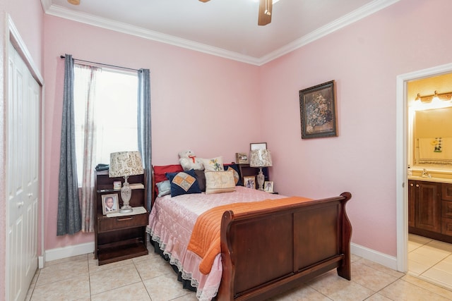 tiled bedroom with a closet, ceiling fan, ornamental molding, sink, and connected bathroom