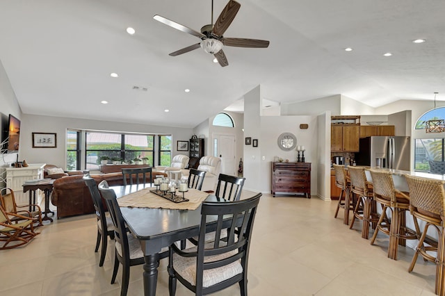 dining area with ceiling fan and vaulted ceiling