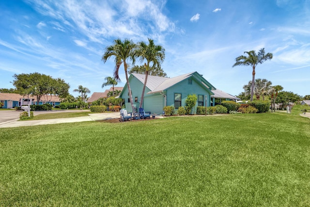 view of side of property with a garage and a yard