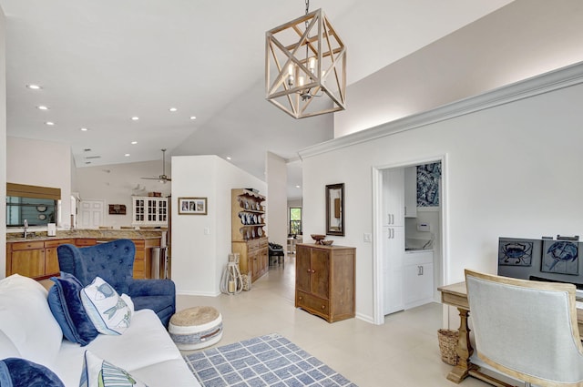 living room with high vaulted ceiling, sink, and ceiling fan with notable chandelier