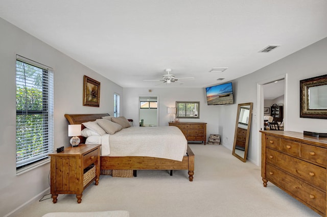 bedroom with ceiling fan and light colored carpet