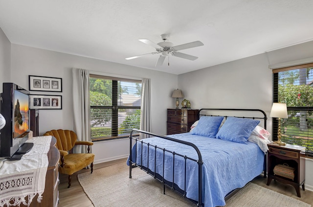 bedroom with light wood-type flooring and ceiling fan