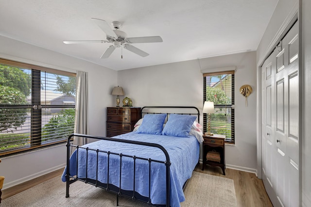 bedroom with ceiling fan, a closet, and hardwood / wood-style flooring